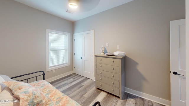 bedroom featuring light wood-type flooring and a closet