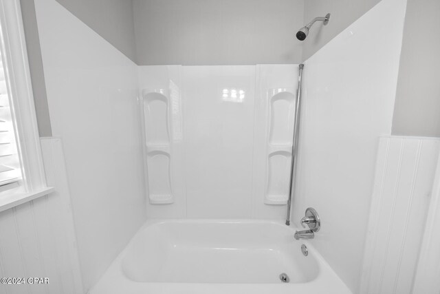 bathroom with bathing tub / shower combination