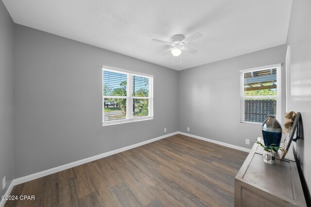 interior space with ceiling fan and dark hardwood / wood-style flooring