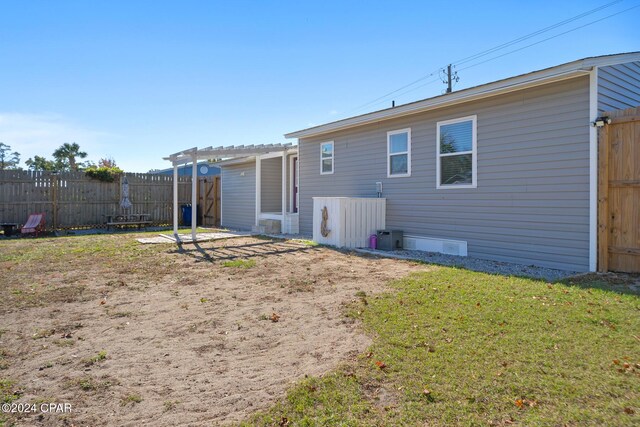 back of house with a pergola