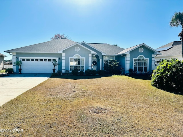 single story home with a front lawn and a garage