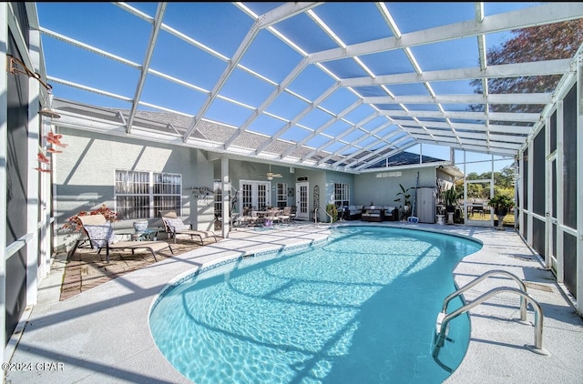 view of pool featuring a lanai, ceiling fan, and a patio