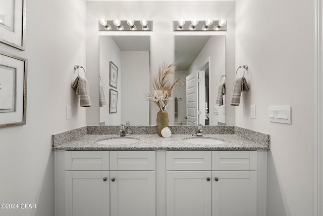 bathroom with double vanity and a sink