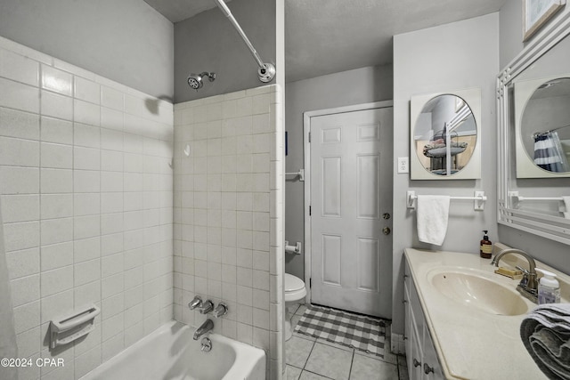 full bathroom with tile patterned flooring, vanity, toilet, and tiled shower / bath