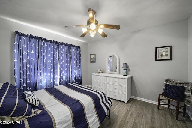 bedroom featuring ceiling fan and dark wood-type flooring