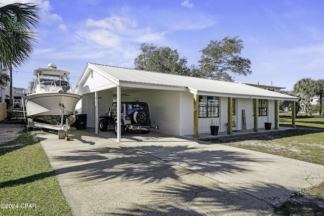 view of front of home with covered porch and a carport