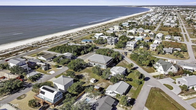 drone / aerial view featuring a water view and a beach view