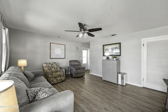 living room with ceiling fan and dark hardwood / wood-style floors