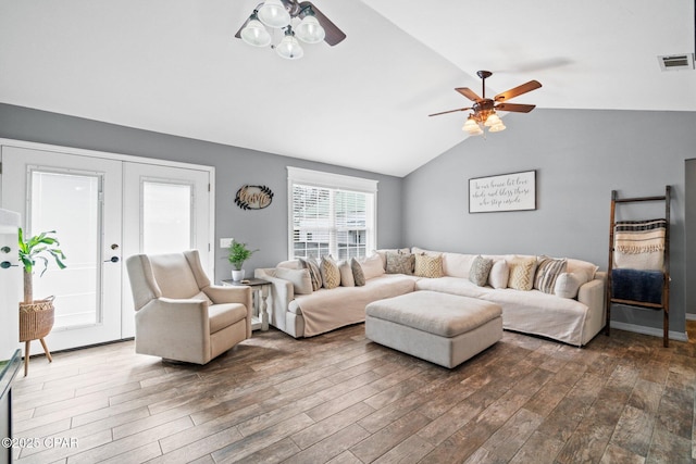 living room featuring dark hardwood / wood-style floors, ceiling fan, lofted ceiling, and french doors