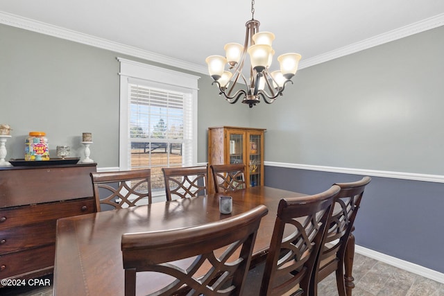 dining space featuring crown molding and an inviting chandelier