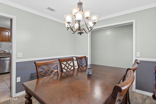 dining space featuring crown molding and a chandelier