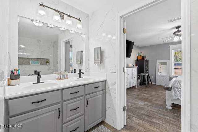 bathroom with hardwood / wood-style flooring, ceiling fan, and vanity