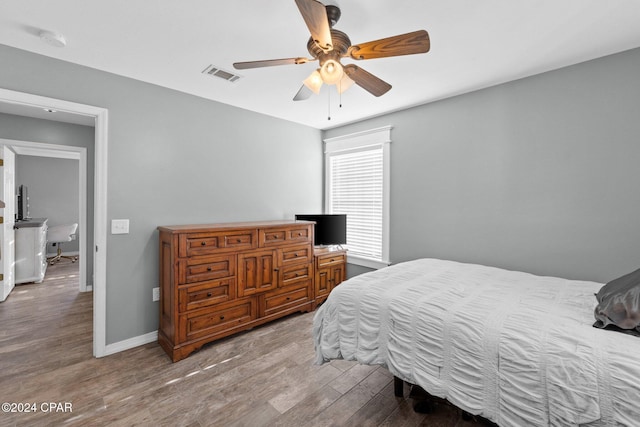 bedroom with ceiling fan and light wood-type flooring