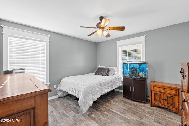 bedroom with hardwood / wood-style floors and ceiling fan