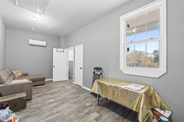 interior space featuring hardwood / wood-style flooring and an AC wall unit