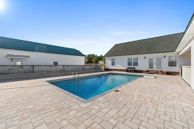 view of swimming pool featuring french doors, grilling area, and a patio area