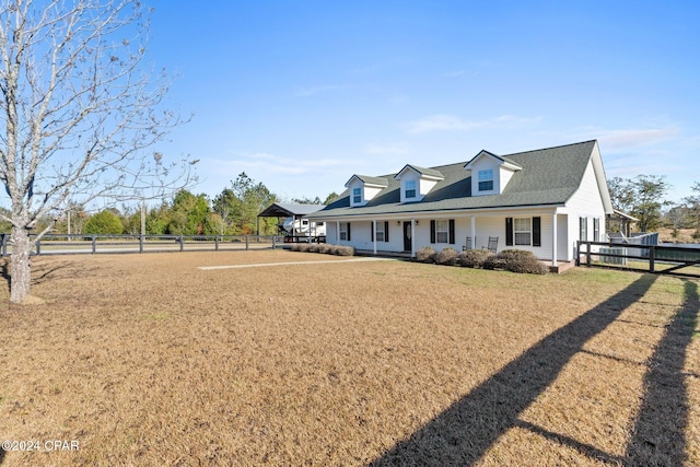 cape cod home with a front yard