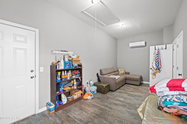 bedroom with wood-type flooring and a wall unit AC