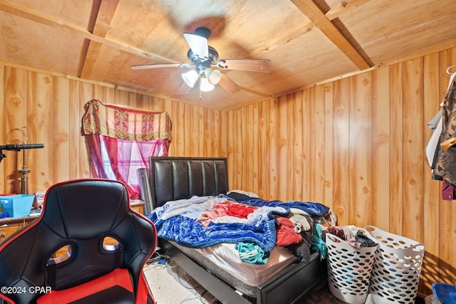 carpeted bedroom featuring ceiling fan, wooden ceiling, and wooden walls