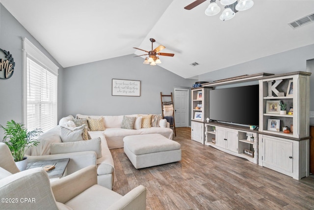 living room with ceiling fan, wood-type flooring, and vaulted ceiling