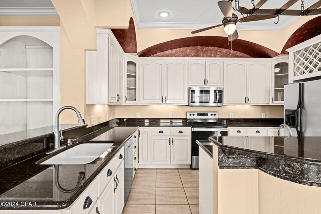 kitchen with white cabinetry, sink, appliances with stainless steel finishes, and vaulted ceiling