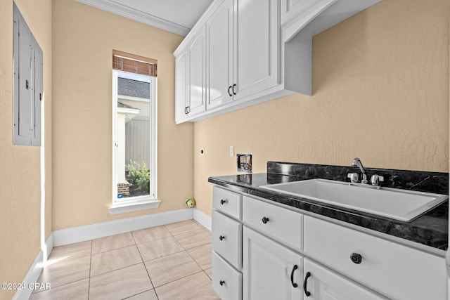 kitchen featuring crown molding, sink, white cabinets, electric panel, and light tile patterned flooring