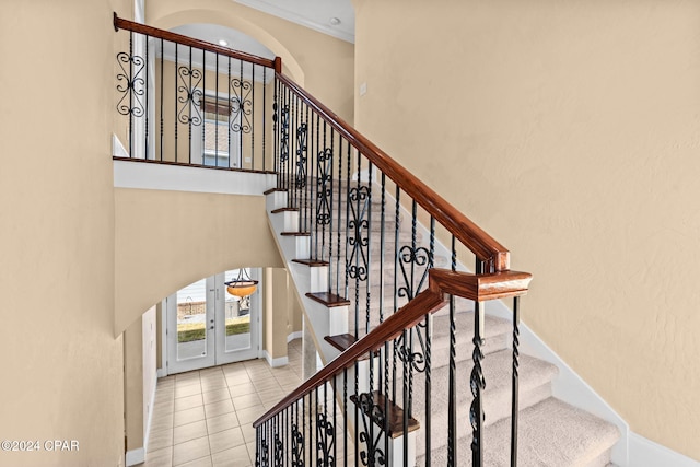 staircase with tile patterned flooring and french doors