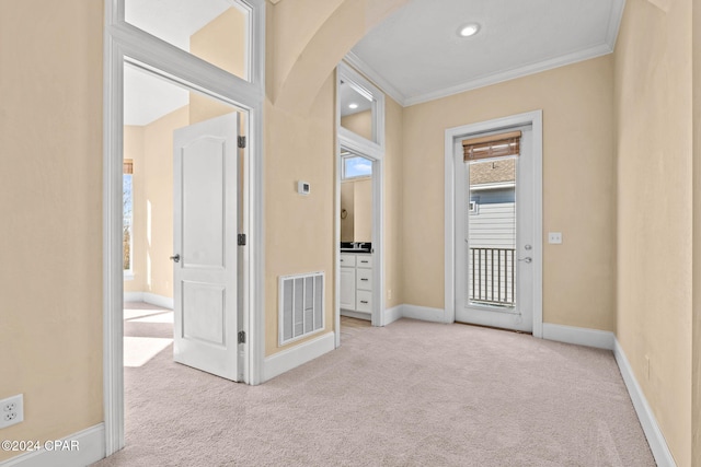 hall featuring light colored carpet and ornamental molding