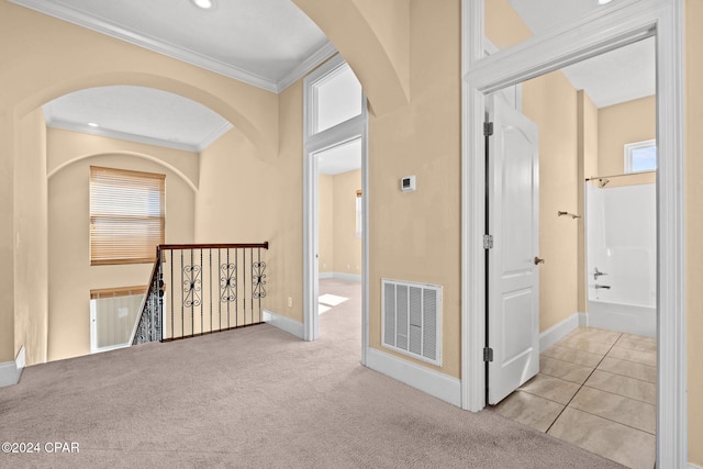 hall featuring light carpet and crown molding