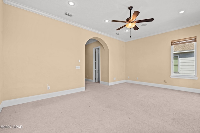 carpeted spare room featuring ceiling fan and ornamental molding