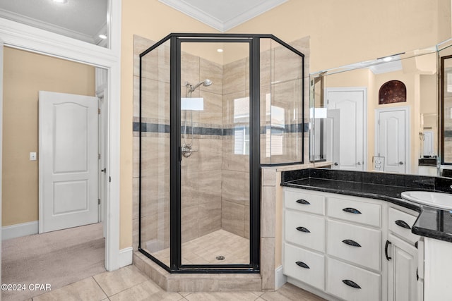 bathroom with vanity, tile patterned floors, a shower with door, and crown molding