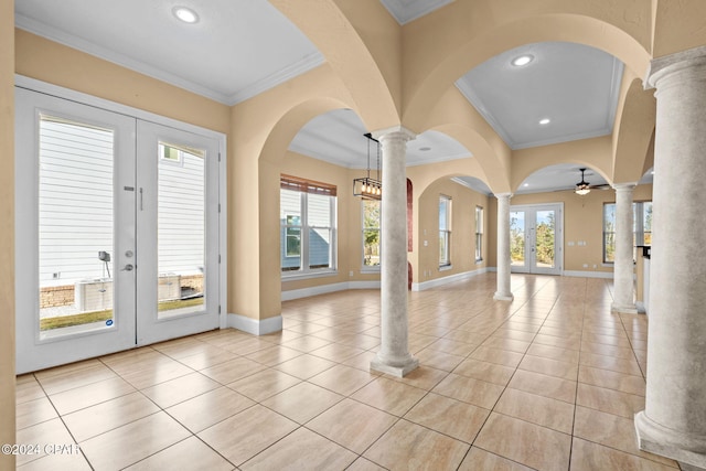 tiled foyer featuring french doors, plenty of natural light, and crown molding