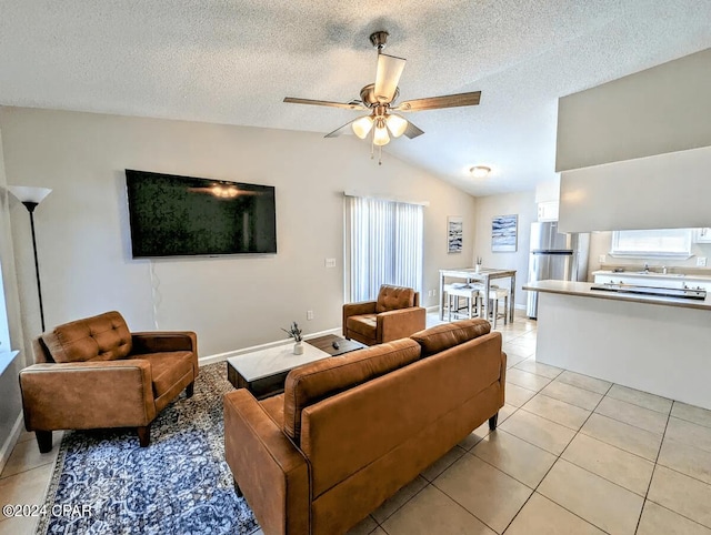 living room featuring light tile patterned floors, a textured ceiling, and vaulted ceiling