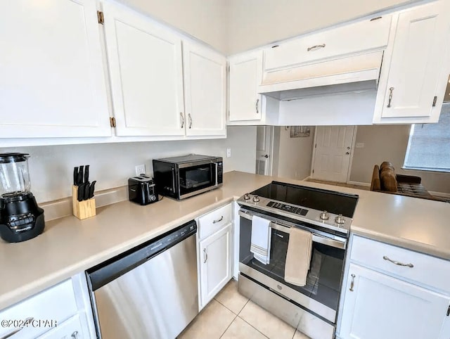 kitchen with white cabinetry, stainless steel appliances, and light tile patterned floors