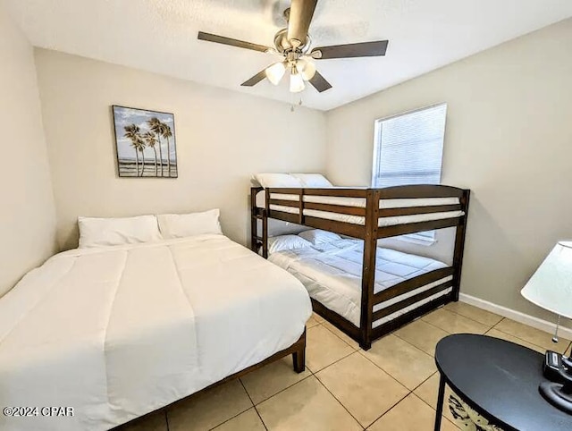 tiled bedroom featuring ceiling fan