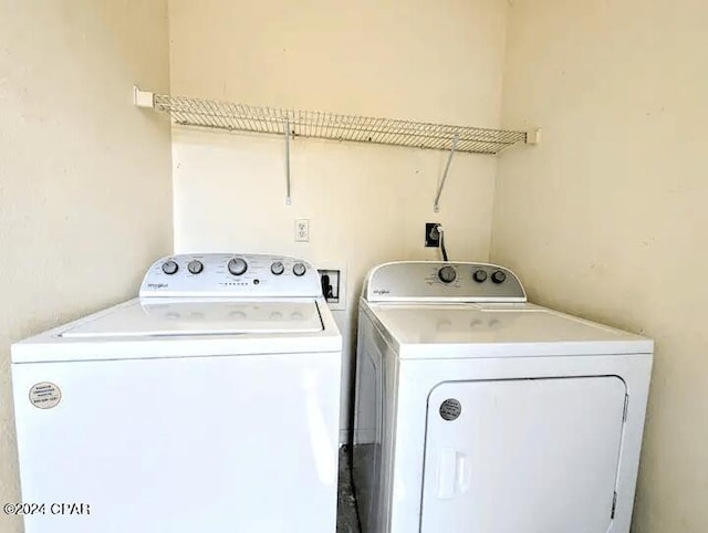 clothes washing area with separate washer and dryer