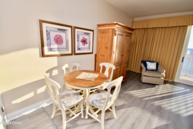 dining space with wood-type flooring