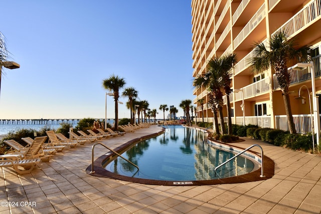 view of pool with a water view