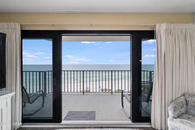 interior space with a water view and a view of the beach