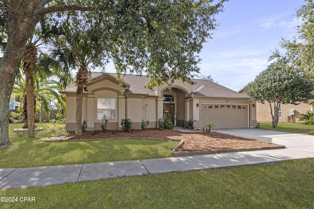 view of front of house featuring a garage and a front lawn