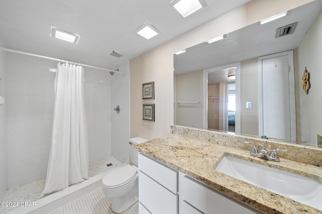 bathroom with vanity, tile patterned flooring, toilet, and walk in shower