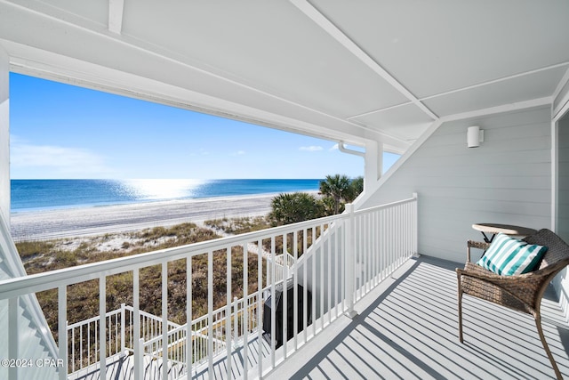 balcony with a water view and a beach view