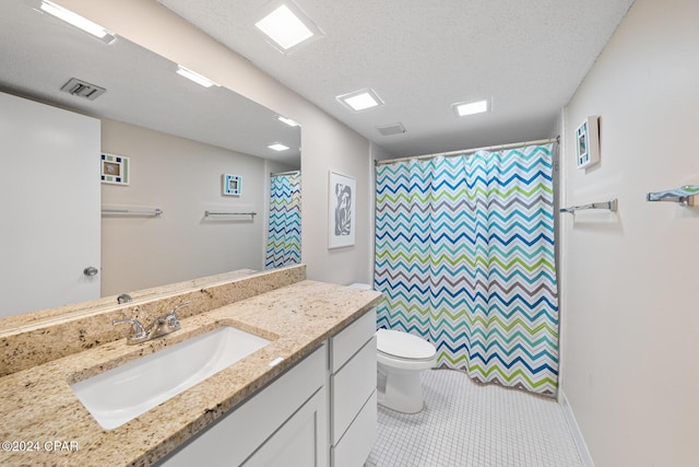 bathroom with vanity, a textured ceiling, a shower with curtain, tile patterned floors, and toilet