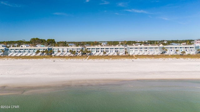 birds eye view of property featuring a water view and a beach view