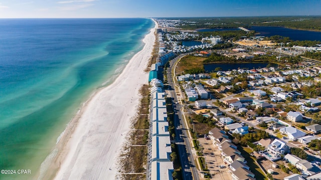 birds eye view of property with a water view and a view of the beach