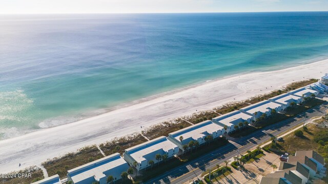 drone / aerial view featuring a water view and a view of the beach