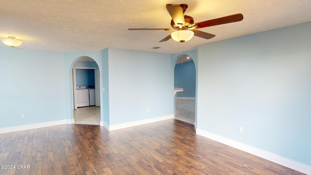 spare room featuring washer and clothes dryer, hardwood / wood-style floors, and a textured ceiling