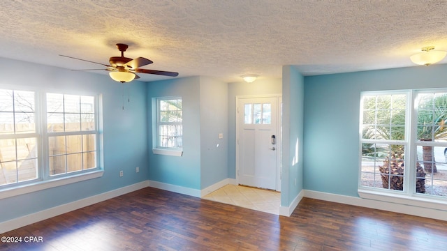 entryway featuring a textured ceiling, hardwood / wood-style flooring, and ceiling fan