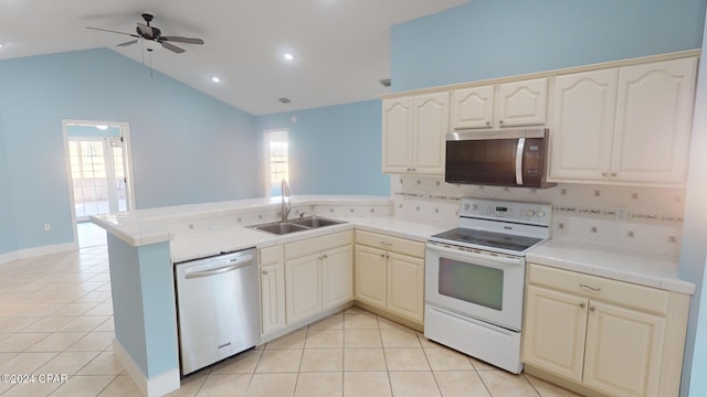 kitchen featuring kitchen peninsula, appliances with stainless steel finishes, vaulted ceiling, and sink