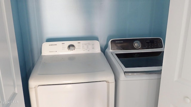 clothes washing area featuring washer and dryer